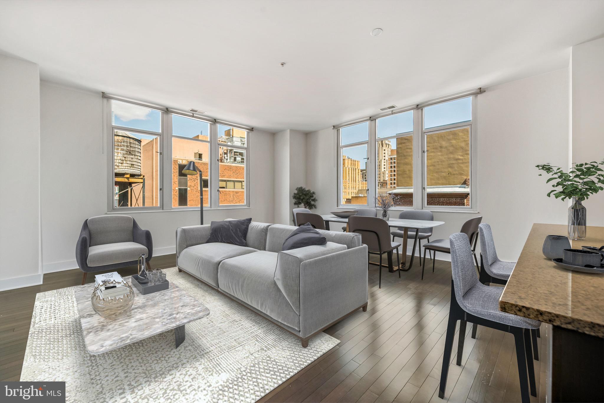 a living room with furniture and floor to ceiling windows