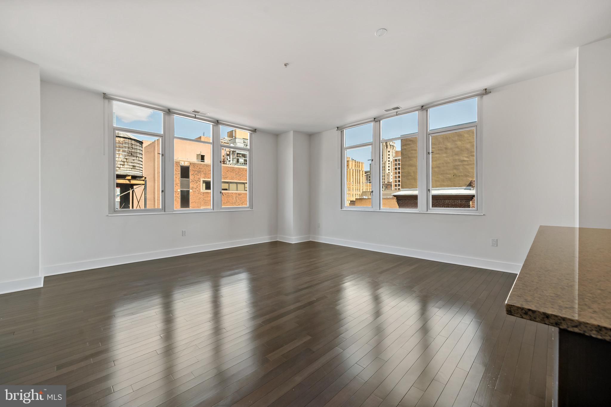 1101 Locust Street, Unit 7I Philadelphia, PA 19107 - Photo 2 of 27 a view of an empty room with wooden floor and a window