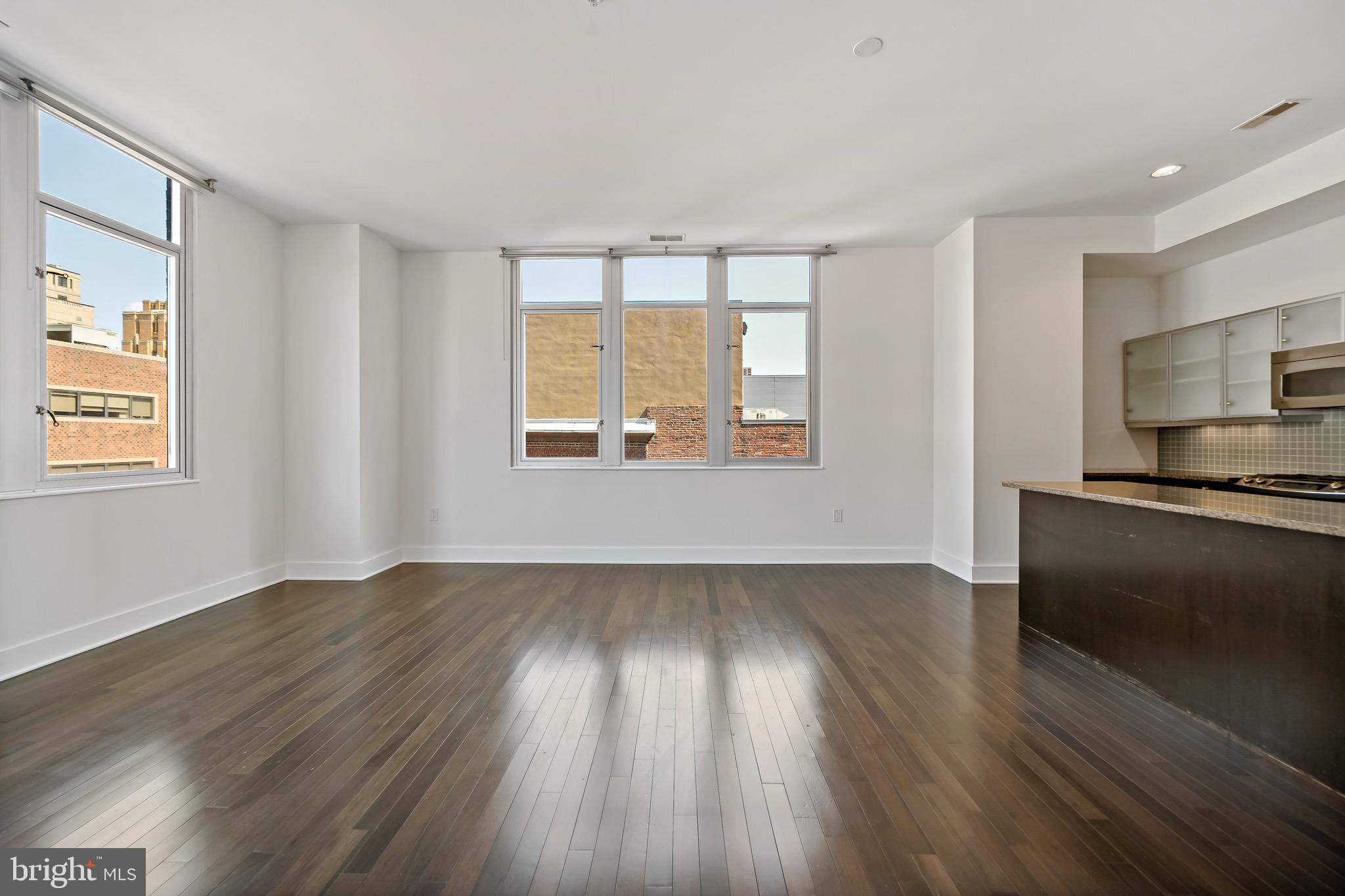 1101 Locust Street, Unit 7I Philadelphia, PA 19107 - Photo 3 of 27 a view of an empty room with a window and wooden floor