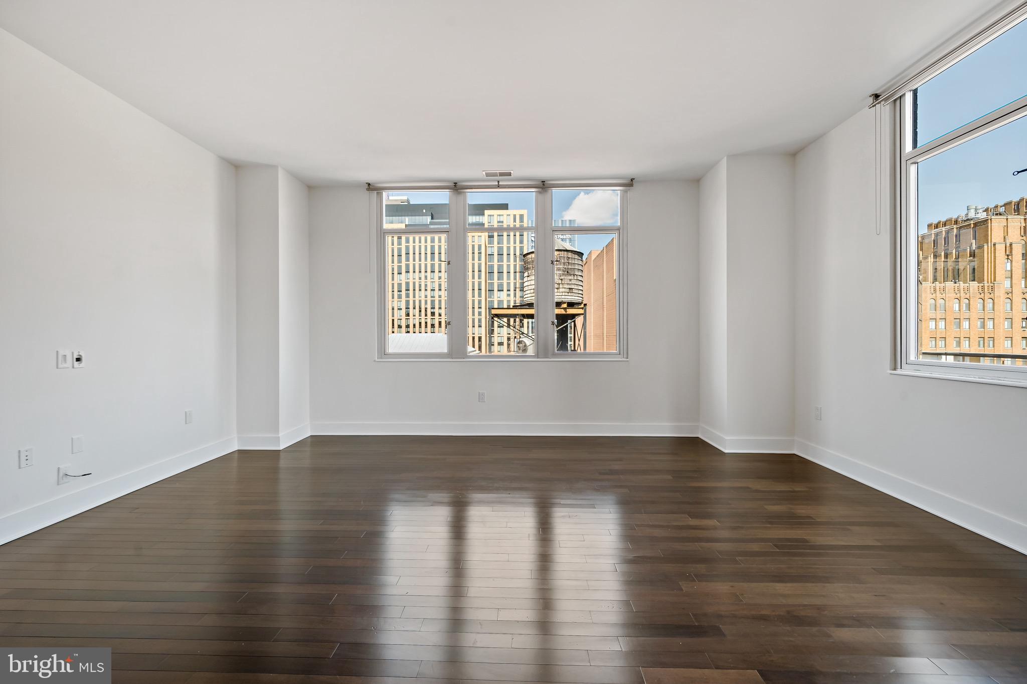 1101 Locust Street, Unit 7I Philadelphia, PA 19107 - Photo 4 of 27 a view of an empty room with wooden floor and a window