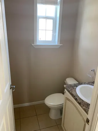 a white toilet sitting next to a bathroom sink