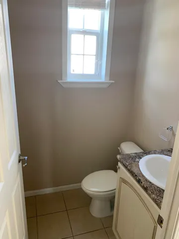 a white toilet sitting next to a bathroom sink