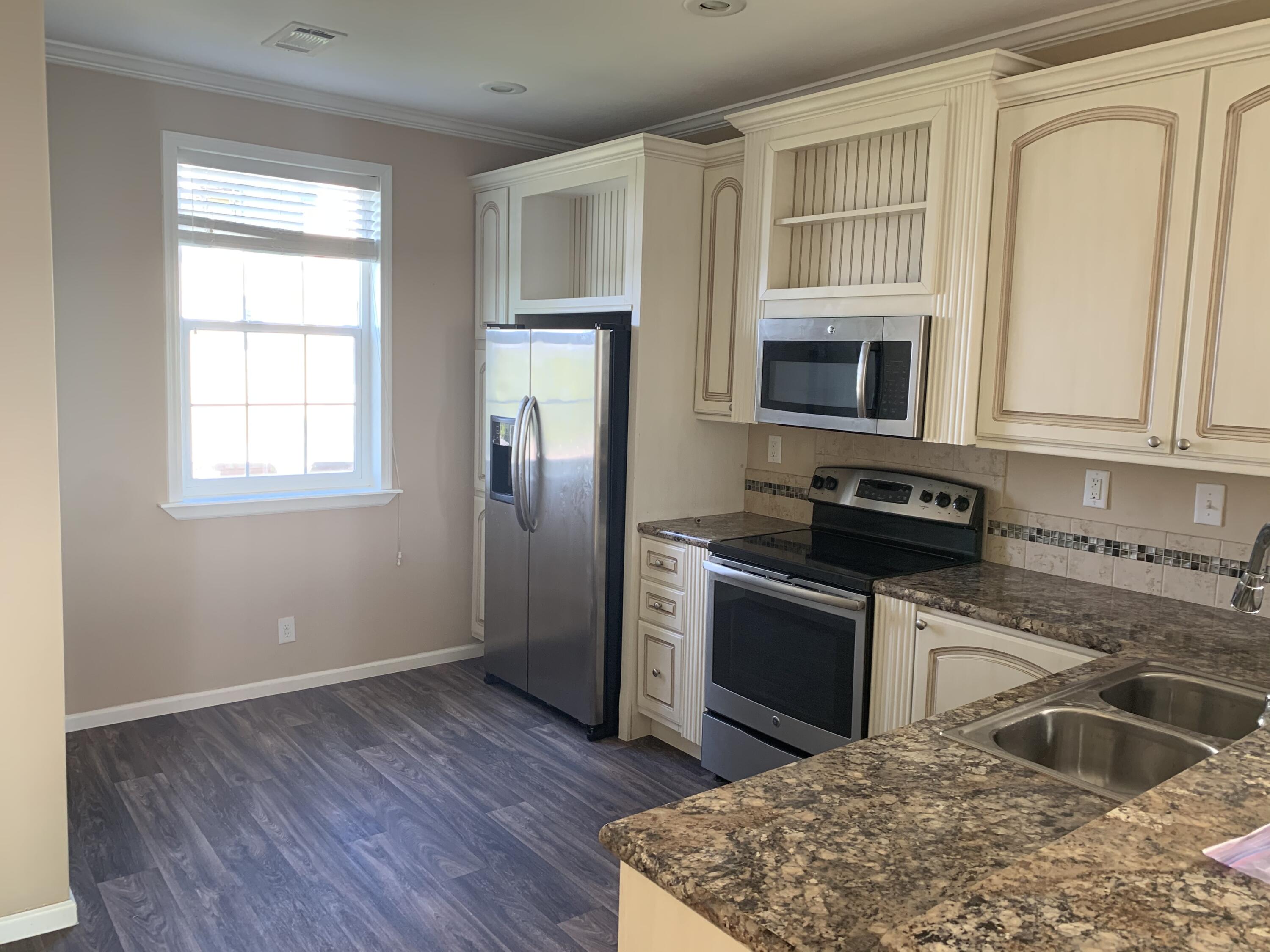 28511 Channel View Drive Summerland Key, FL 33042 - Photo 10 of 14 a kitchen with granite countertop a stove a sink and a microwave