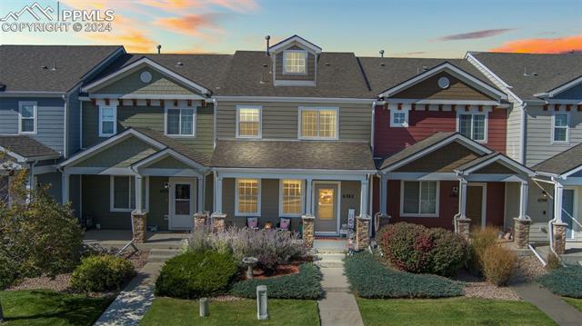 6382 Pilgrimage Road Colorado Springs, CO 80925 - Photo 3 of 32 Evening view of front of townhome