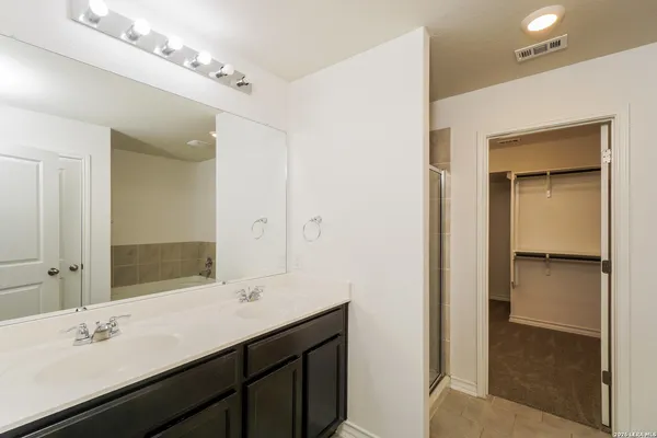 a bathroom with a sink double vanity and a mirror