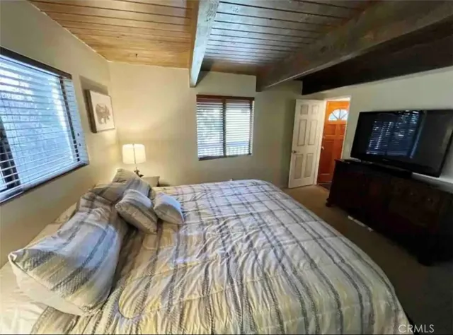 a bedroom with a bed next to a window