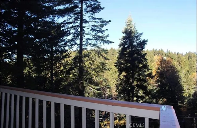 a view of a balcony with wooden fence and floor