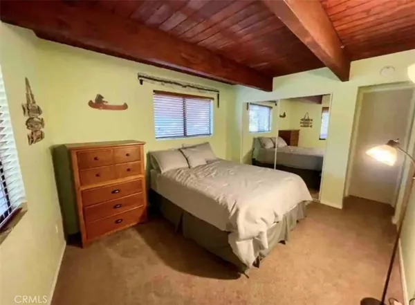 a spacious bedroom with a bed and a dresser