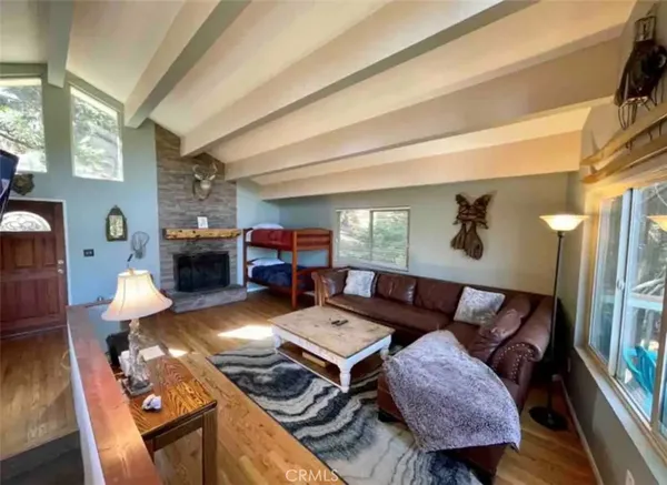 a living room with furniture fireplace and a table