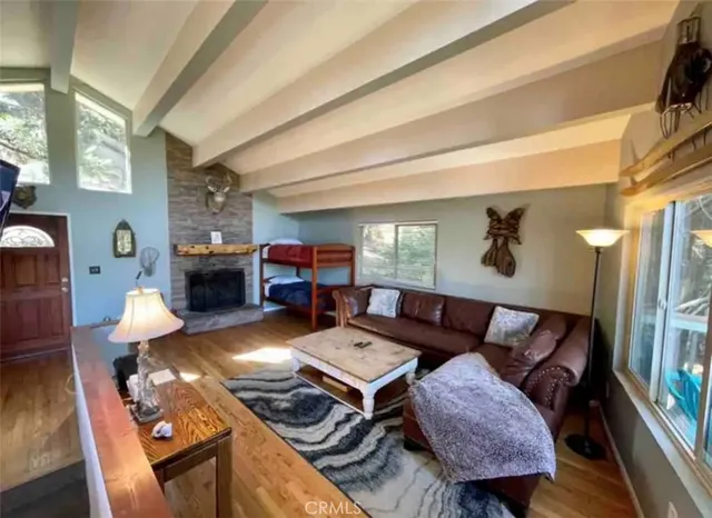 a living room with furniture fireplace and a table