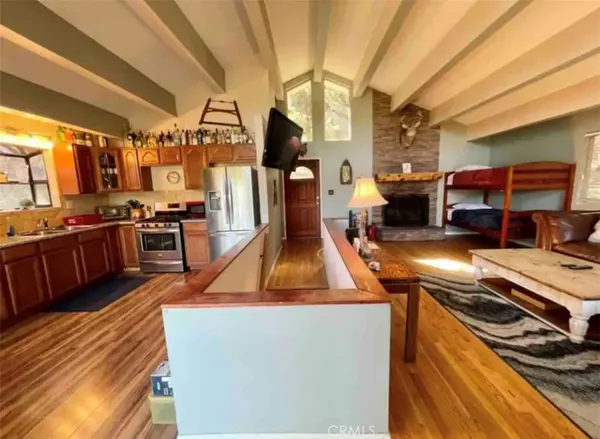 a kitchen filled with a stove and chairs