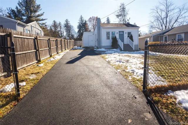 a view of a house with a yard covered in snow