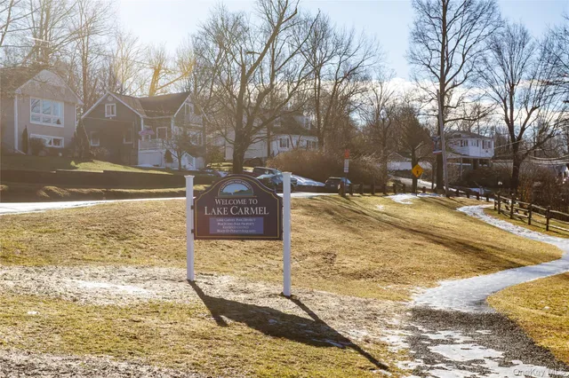 a street view with wooden fence and trees