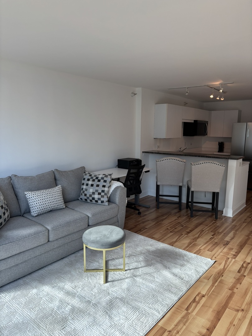 2 East Erie Street, Unit 2204 Chicago, IL 60611 - Photo 14 of 25 a living room with furniture and a wooden floor