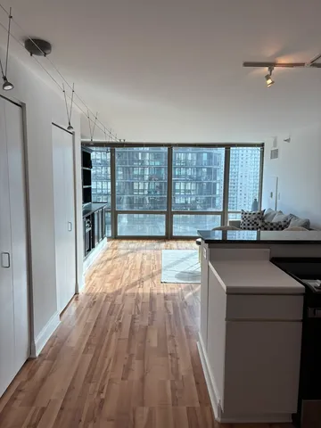 a view of kitchen island with wooden floor and stainless steel appliances