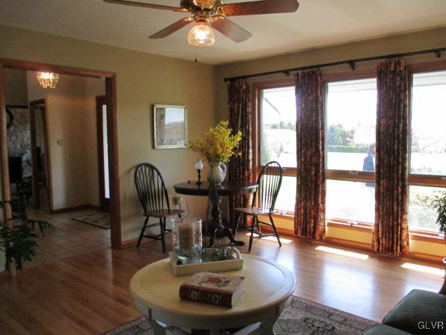 343 Forest Road Nazareth, PA 18064 - Photo 12 of 32 a dining room with wooden floor a chandelier a glass table and windows