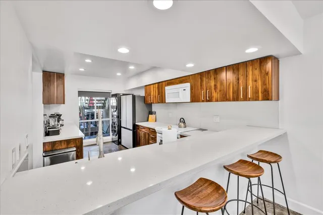 a kitchen with stainless steel appliances a refrigerator and a sink