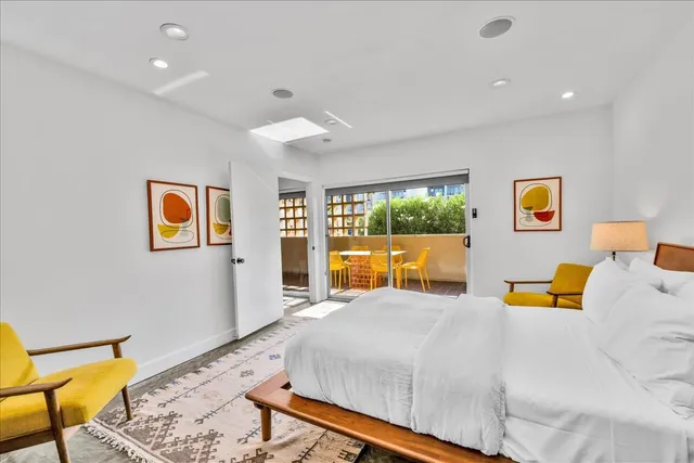 a bed room with a bed and a chair