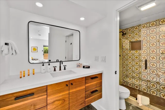 a bathroom with a double vanity sink mirror double and shower