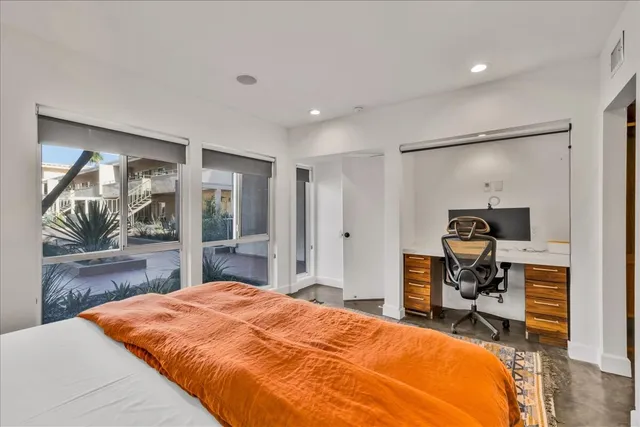 a bedroom with a bed and a mirror