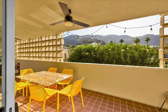 a view of balcony with table and chairs
