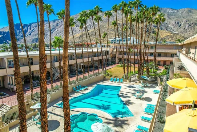 a view of swimming pool with a patio and a yard