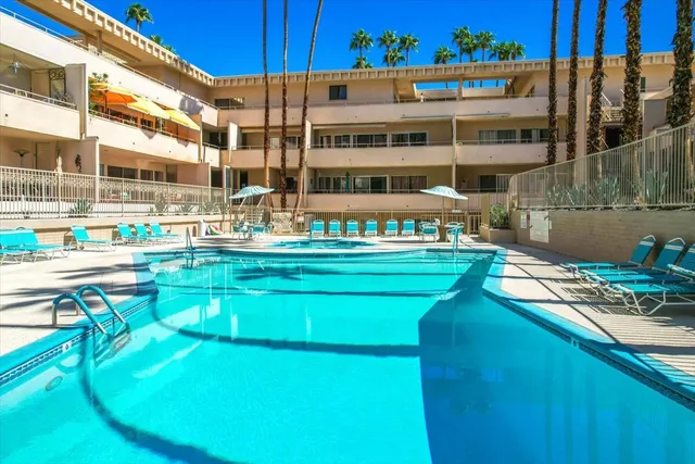 a view of a swimming pool with outdoor seating