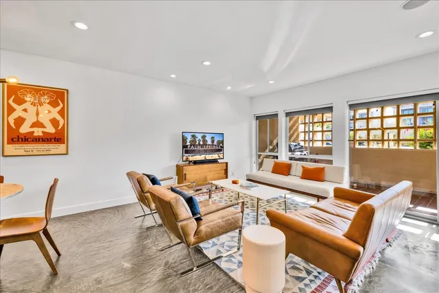 a living room with furniture and a floor to ceiling window