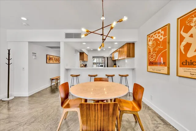 a dining room with furniture and window