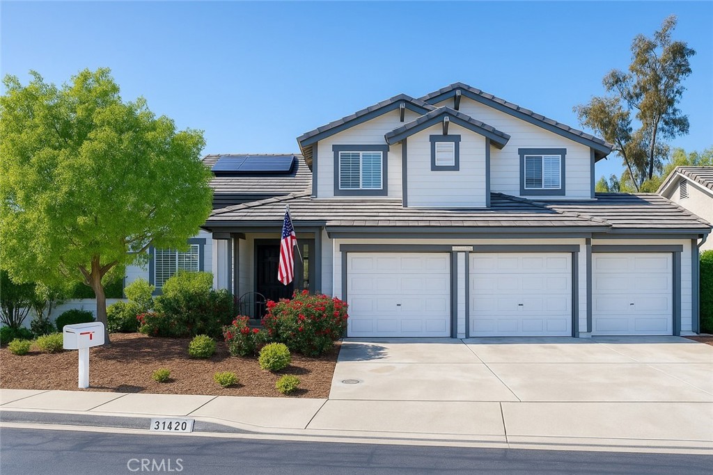 a view of a house with a garden and pathway
