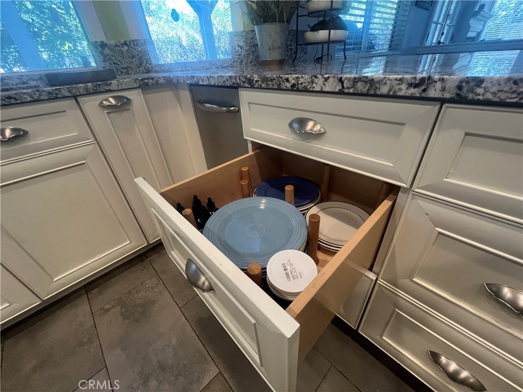 31420 Corte Madera Temecula, CA 92592 - Photo 15 of 54 a kitchen with a sink a stove oven and cabinetry