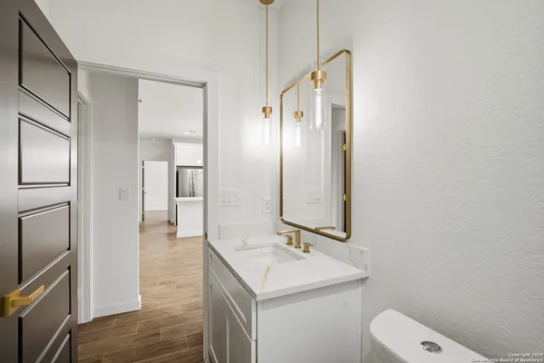 a bathroom with a sink a toilet and mirror