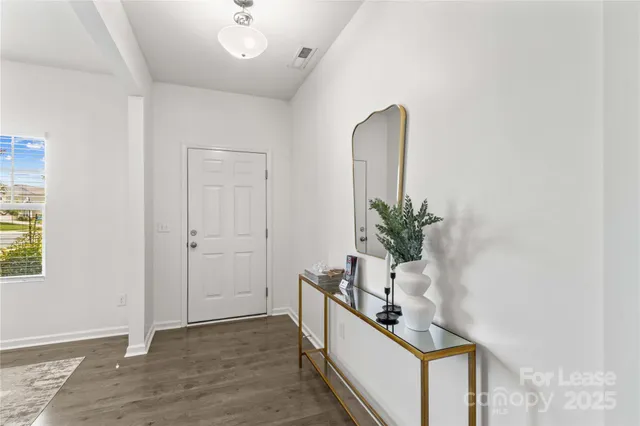 a dining room with furniture a chandelier and window
