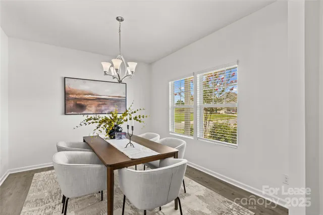 a view of a dining room with furniture and chandelier