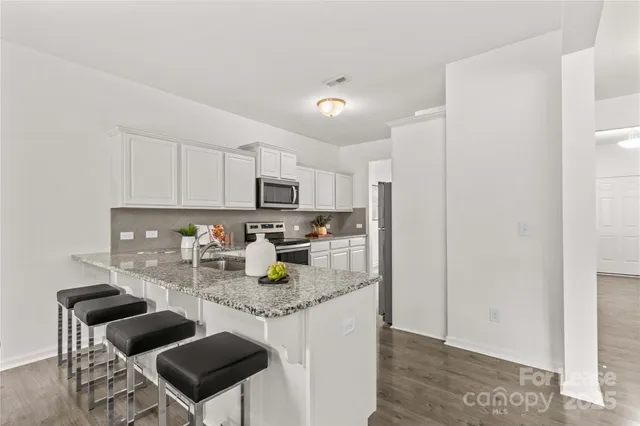 a kitchen with sink and glass window