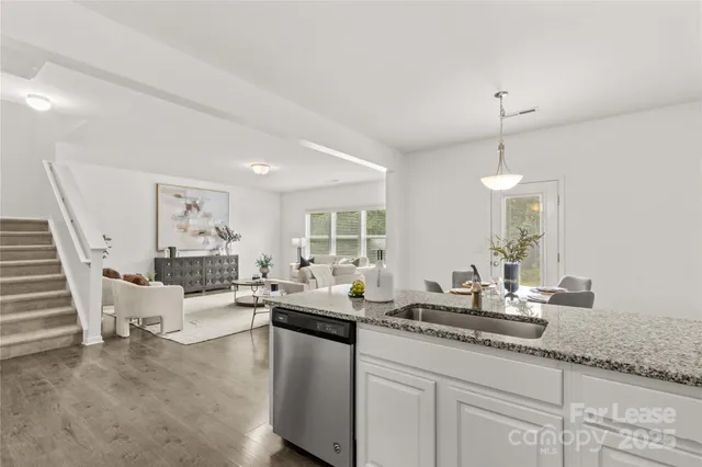 a kitchen with granite countertop a sink and cabinets