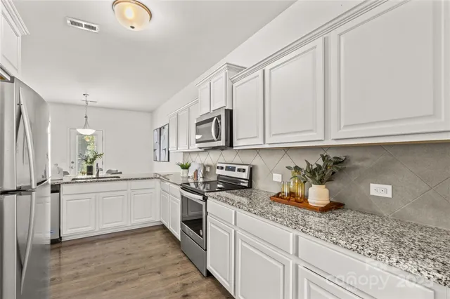 a living room with furniture and a large window with outer view