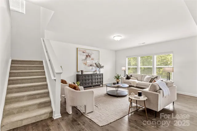 a bedroom with furniture and a large window