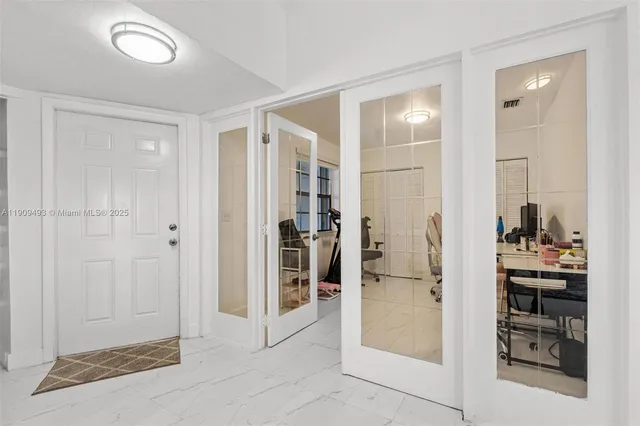 a workspace with furniture and a air conditioner vent