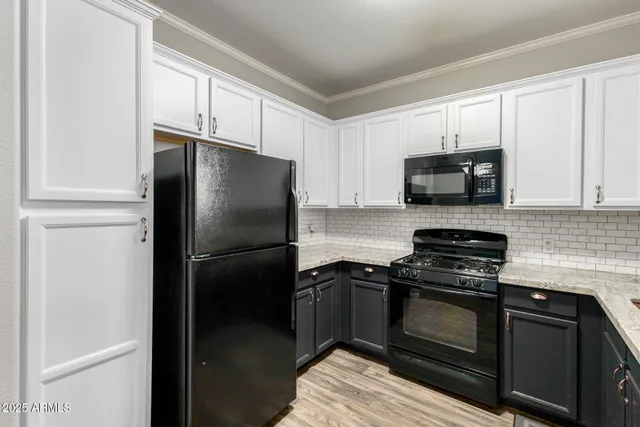a kitchen with a refrigerator stove and microwave