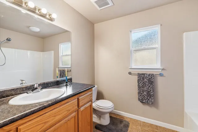 a bathroom with double vanity sinks and a mirror