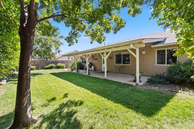 a view of a porch with furniture and garden