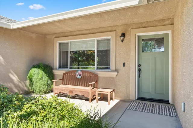 a living room with furniture a ceiling fan and a flat screen tv