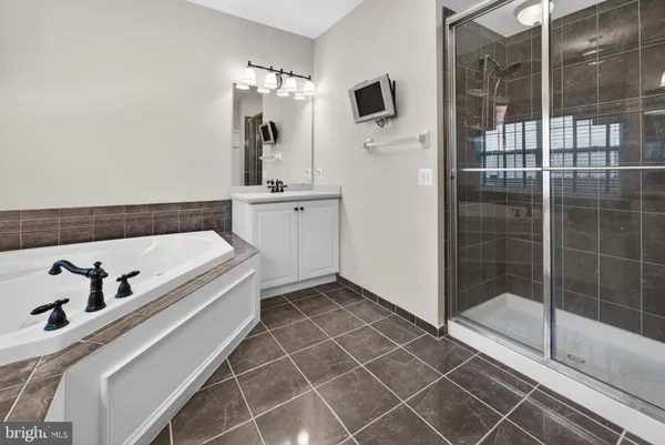 a bathroom with a bathtub and a shower