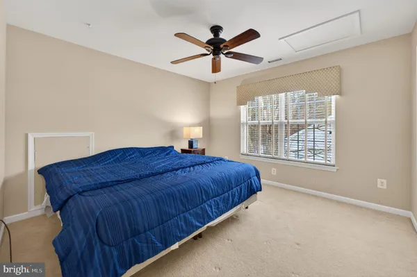 a bedroom with a bed and window