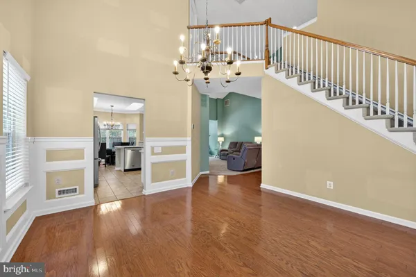 a view of an entryway and livingroom with wooden floor
