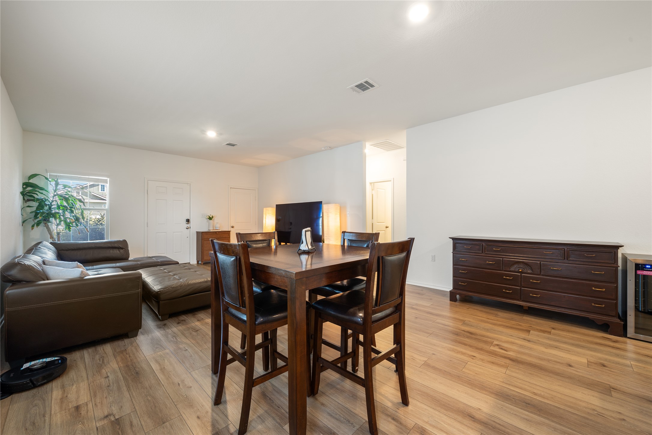 14404 Berning Road Manor, TX 78653 - Photo 10 of 38 An inviting open-concept living and dining area with warm wood flooring welcomes you.