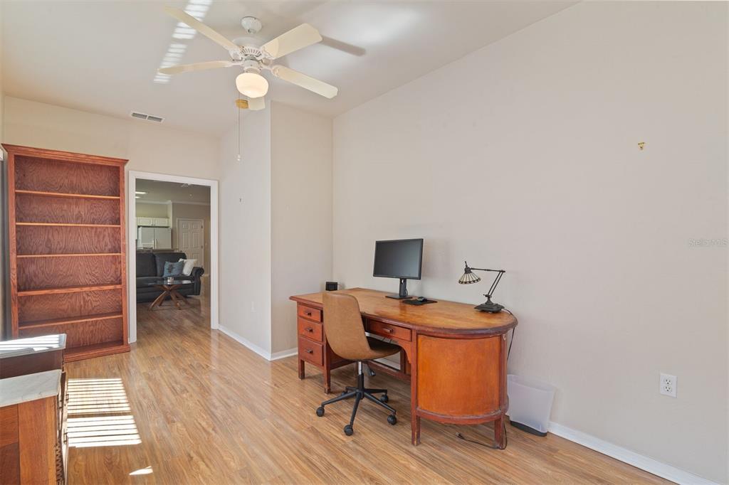 4748 Northwest 77 Road Gainesville, FL 32653 - Photo 14 of 21 a room with chandelier fan and wooden floor