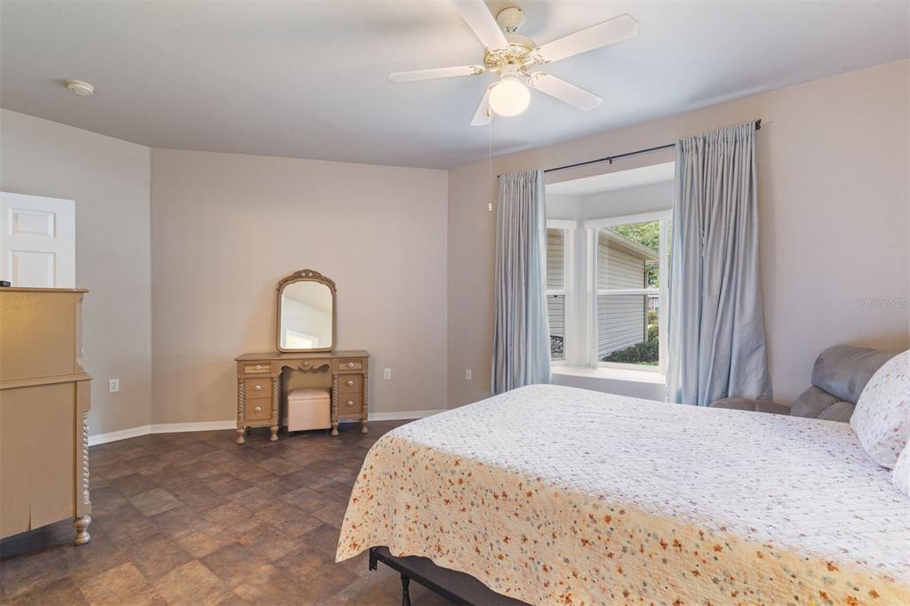 4748 Northwest 77 Road Gainesville, FL 32653 - Photo 16 of 21 a bedroom with a bed and a table