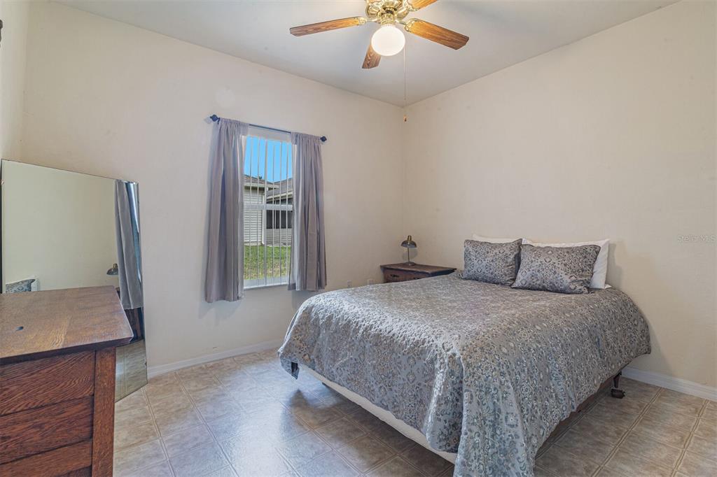 4748 Northwest 77 Road Gainesville, FL 32653 - Photo 19 of 21 a bedroom with a bed and a mirror